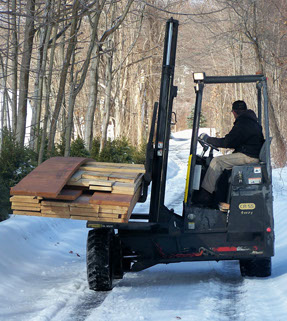 Palfinger CR55 4-way Crayler Forklift traveling down snowy road to job site.